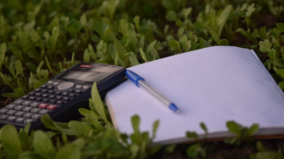 calculator and pad on grass